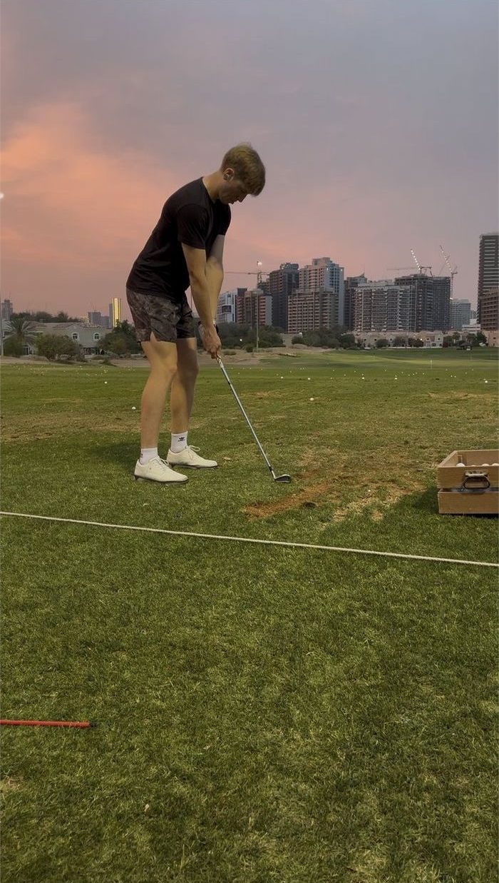 Kallan mid swing at a driving range